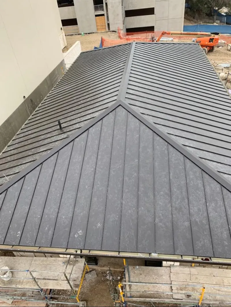 Commercial metal roof construction with crane equipment in Clarks Summit